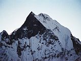 202 Machapuchare Close Up Before Sunrise From Annapurna Sanctuary Base Camp Here is a close up of Machapuchare (6993m) before sunrise from Annapurna Sanctuary Base Camp. The only attempt to climb Machapuchare was in 1957 by a British team led by Jimmy Roberts. Climbers Wilfred Noyce and D. M. Cox climbed to within 50m of the summit via the north ridge, but did not complete the ascent; they had promised not to set foot on the actual summit. Since then, the mountain has been declared sacred, and it is now forbidden to climbers.